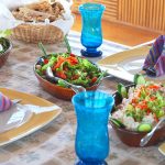 A table set with fresh Egyptian breakfast dishes including salads and flatbread.