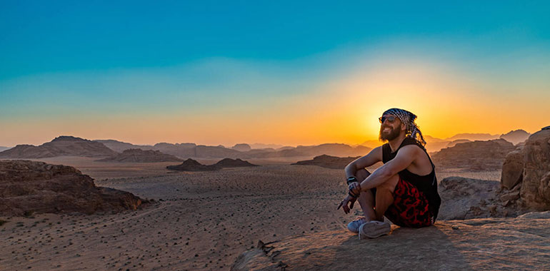 A Man Similing In Wadi Rums Landscape At Sunset