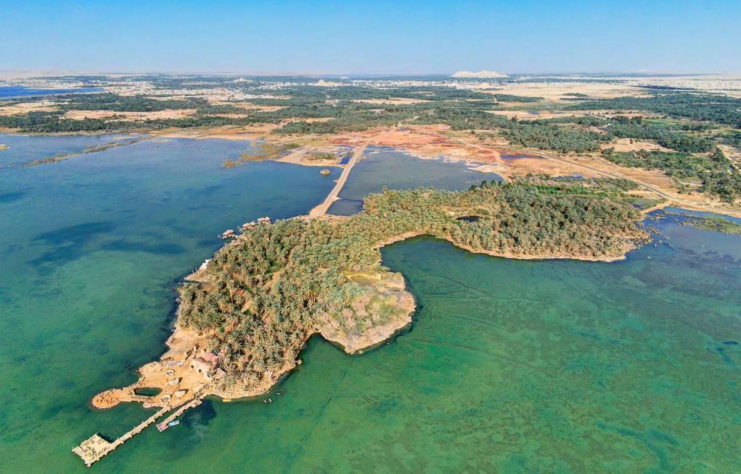 Aerial View Of The Lush, Green Palm Groves And Traditional Low-Rise Buildings Of Siwa Oasis, Egypt.
