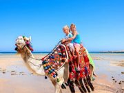Family on the beach in Hurghada, part of a Cairo and Hurghada with Nile Cruise travel package.