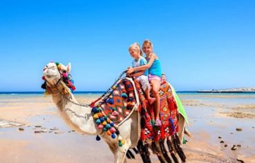 Family on the beach in Hurghada, part of a Cairo and Hurghada with Nile Cruise travel package.