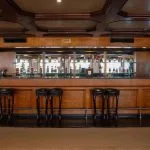 Luxurious wood-paneled bar area inside the MS Commodore Nile Cruise ship