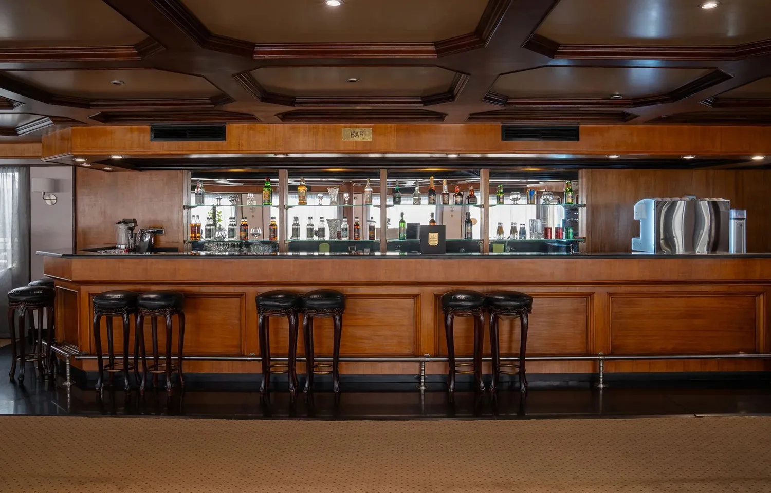 Luxurious wood-paneled bar area inside the MS Commodore Nile Cruise ship