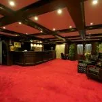 Luxurious reception area with red carpet and wood paneling on the MS Commodore Nile ship.