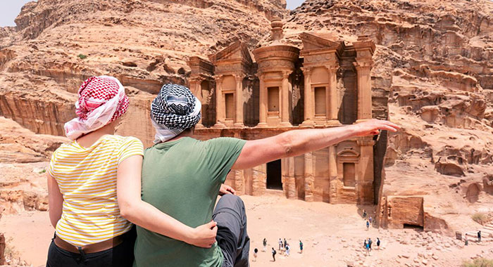 Couple Is Watching The Monastery Of Petra Jordan