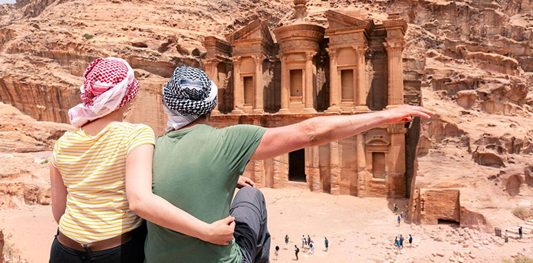 Couple Watching The Monastery Of Petra Jordan