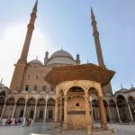 Tourists exploring the stunning architecture of the Mosque of Muhammad Ali during an Old Cairo day trip