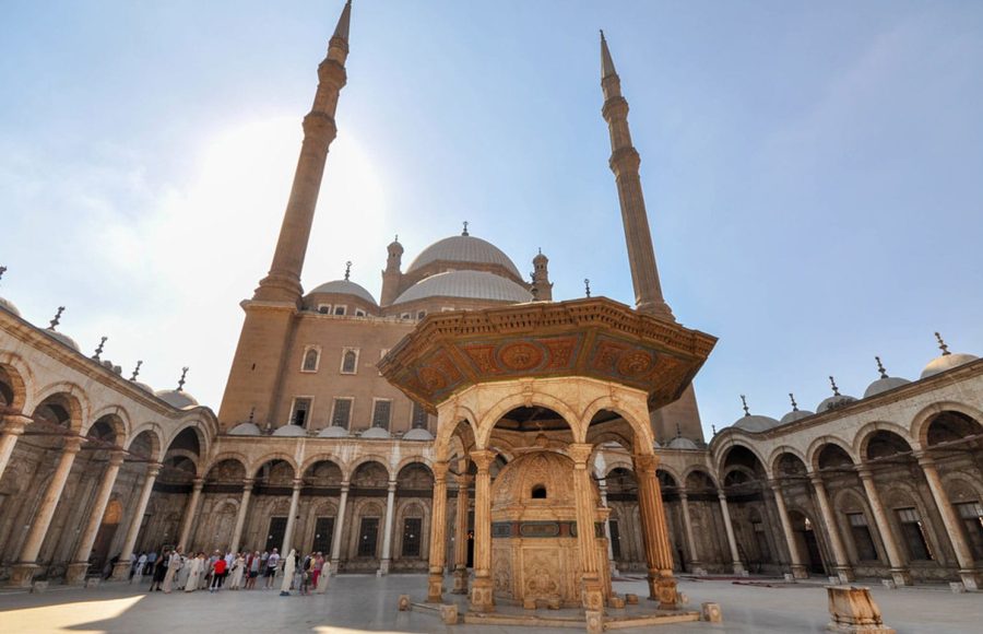 Tourists exploring the stunning architecture of the Mosque of Muhammad Ali during an Old Cairo day trip