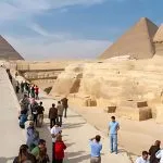Crowds of tourists exploring the Great Sphinx and Giza Pyramids during a long layover in Cairo tour