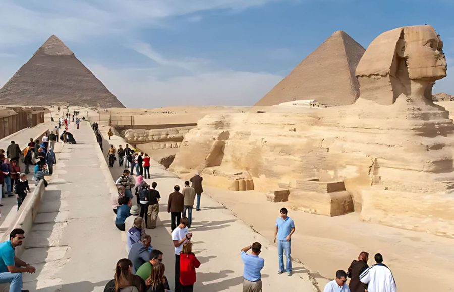 Crowds of tourists exploring the Great Sphinx and Giza Pyramids during a long layover in Cairo tour