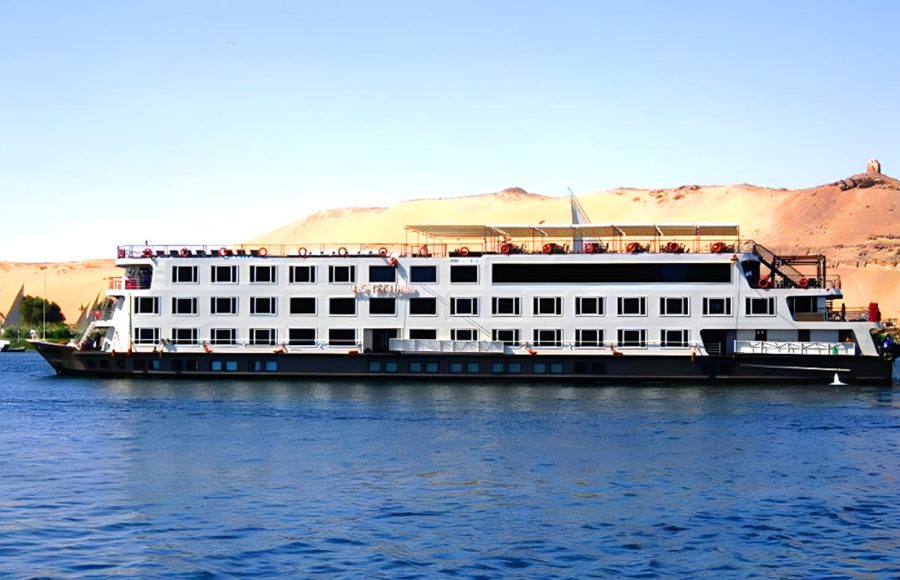 A Nile Cruise ship sailing past sandy riverbanks, part of the best Egypt all inclusive tour.