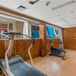 Small cruise ship gym with treadmill and exercise bike.