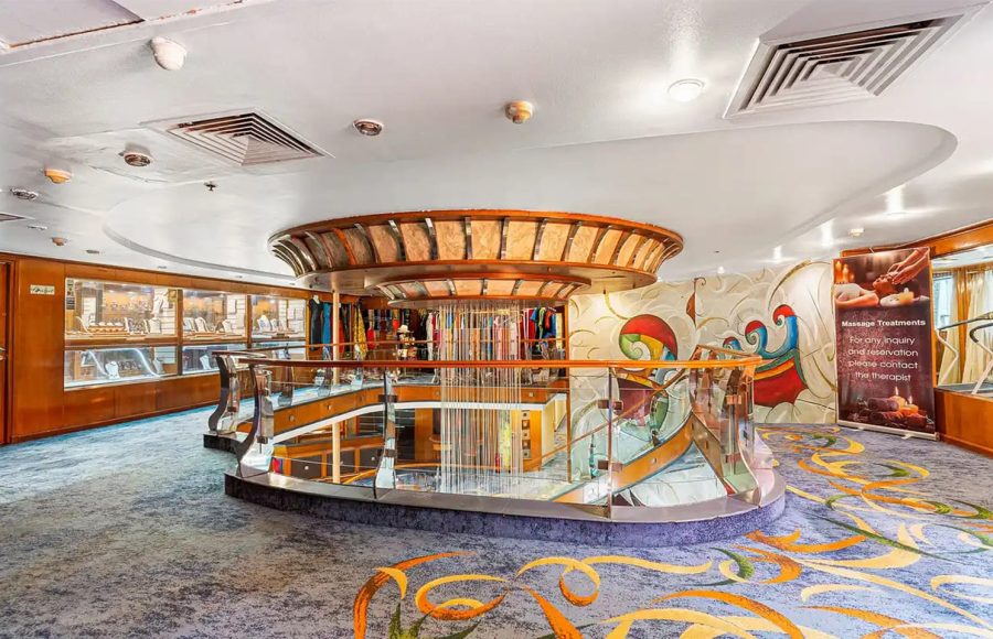 Nile cruise sundeck dining area with tables and river view.