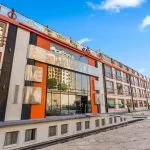 Exterior of Nile cruise ship docked, featuring orange and white facade.