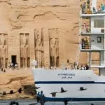 The Mövenpick Prince Abbas cruise ship sailing on deep blue water under a clear sky.