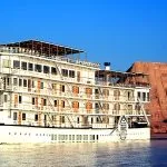 The Mövenpick Prince Abbas cruise ship sailing on deep blue water under a clear sky.