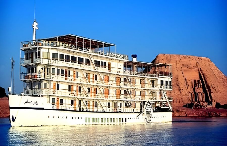 The Mövenpick Prince Abbas cruise ship sailing on deep blue water under a clear sky.