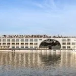 MS Farah Nile cruise ship sailing on the river, showing its distinct central arched window.