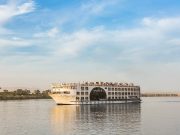 MS Farah Nile cruise ship sailing on the river, showing its distinct central arched window.