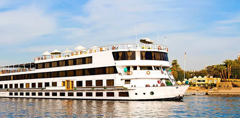 A Cruise Ship Docking Near A River Bank