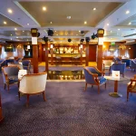 The elegant lounge and bar area, an ideal setting included in the best Cairo Nile Cruise Package.