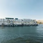 A cruise ship sailing down the Nile River, a highlight of the Cairo and Nile Cruise 7 days trip.