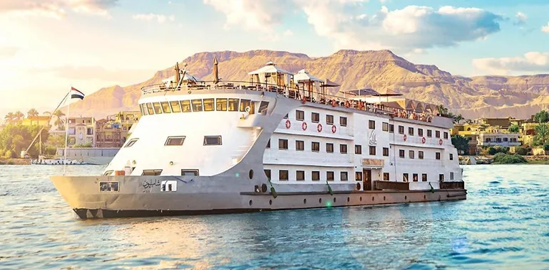 Modern Cruise Ship Sailing Past Mountains And Towns