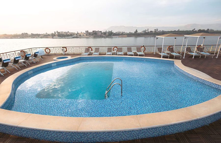 Rounded outdoor swimming pool on a Nile cruise ship deck with sun loungers.