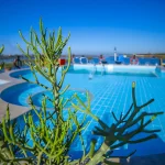 A swimming pool on the sun deck of a Nile cruise ship, a key feature of the Egypt Round Trip with Nile Cruise.