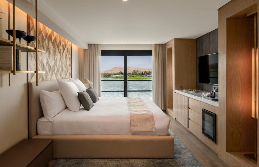 Luxurious MS Soleil Nile Cruise Junior Suite with floor-to-ceiling window overlooking the Nile River.