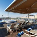 Sun deck with pool, loungers, and canopies on a Nile cruise ship.