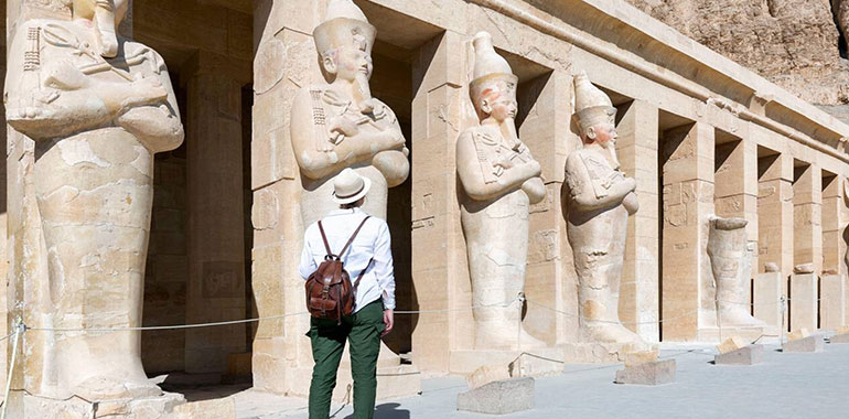 traveler explores the ruins of the ancient Egyptian Hatshepsut temple in the heritage city of